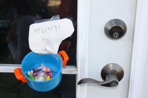 toy pot contains candy and is taped to a door