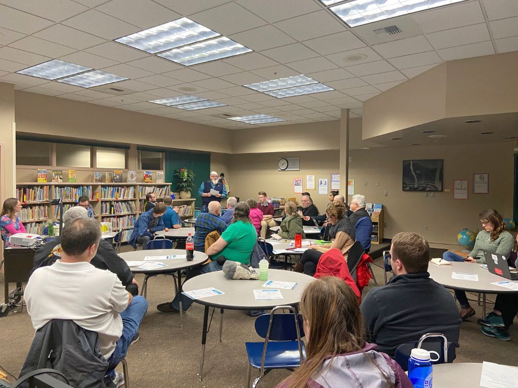 A meeting room full of about 25 people attending the Logan Neighborhood Council meeting.